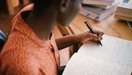 Photo of a student taking notes during a study session. 