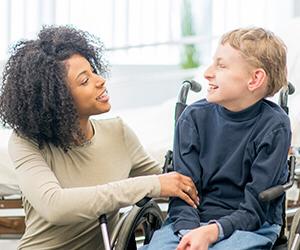 Occupational therapiy assistant working with a child in a wheelchair